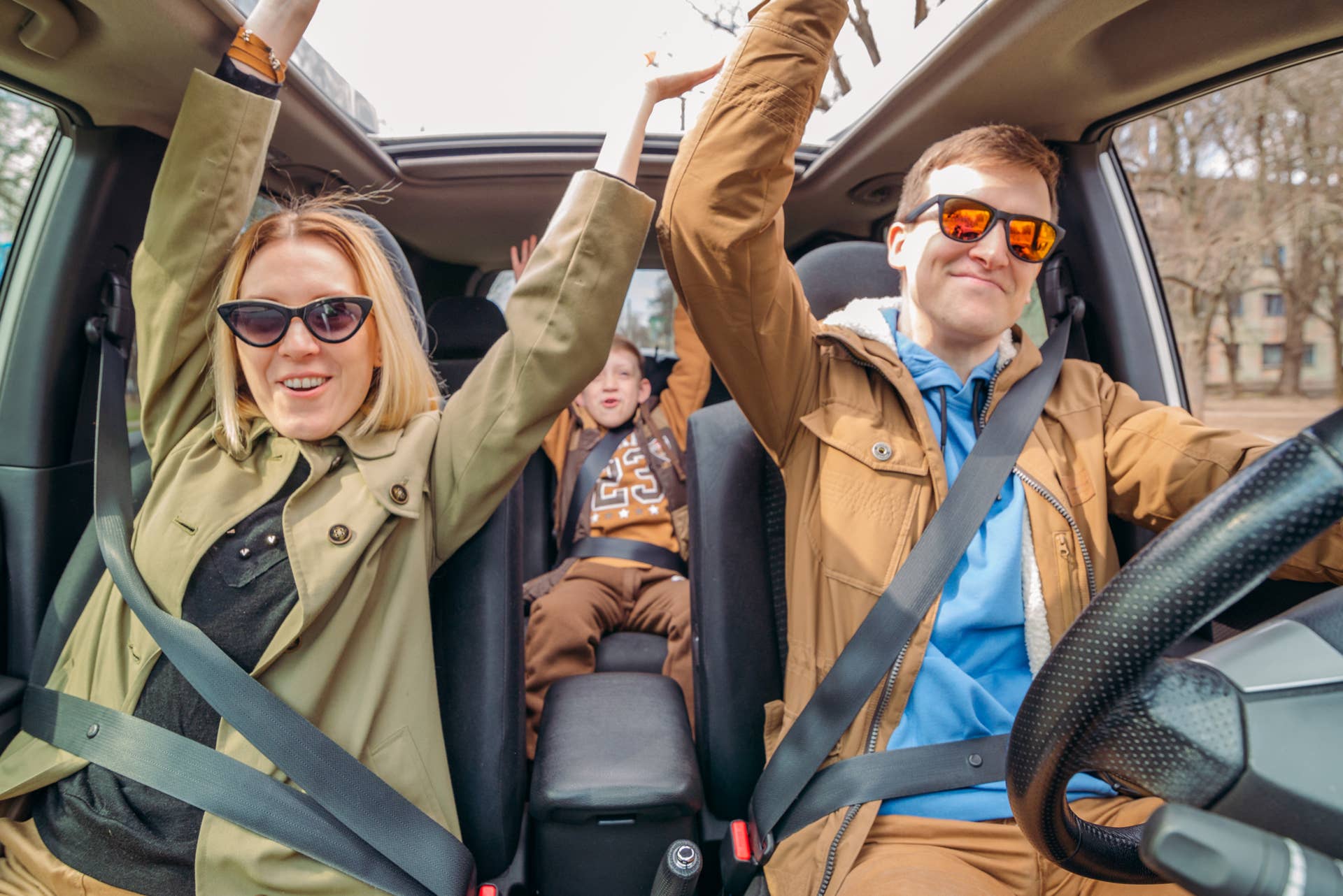 young family with little boy kid inside car. road trip concept. rent a vehicle