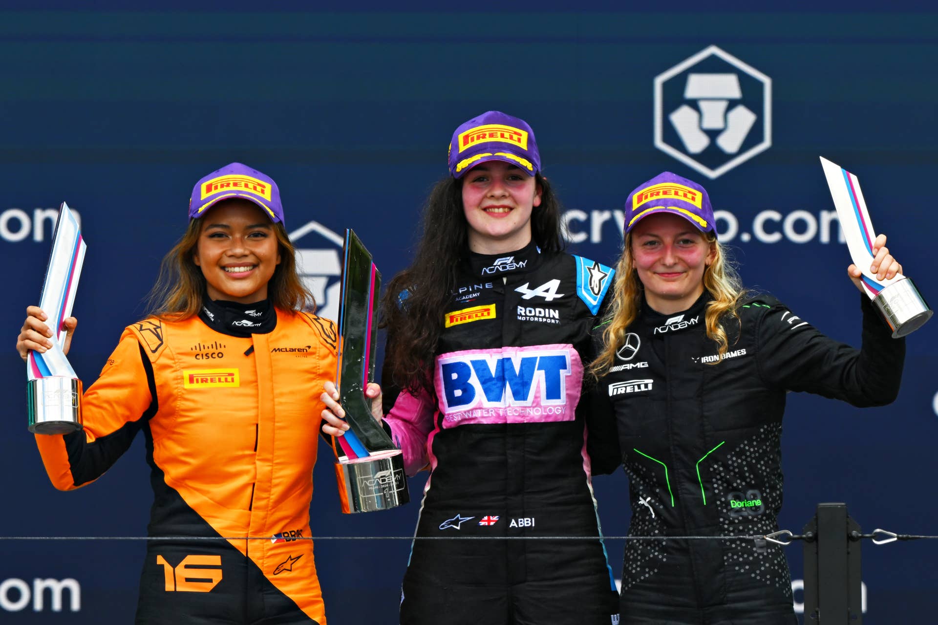 MIAMI, FLORIDA - MAY 05: Race winner Abbi Pulling of Great Britain and Rodin Motorsport (9), Second placed Bianca Bustamante of Philippines and ART Grand Prix (16) and Third placed Doriane Pin of France and PREMA Racing (28) celebrate on the podium during Round 2 Miami race 2 of the F1 Academy at Miami International Autodrome on May 05, 2024 in Miami, Florida. (Photo by Clive Mason/Getty Images)