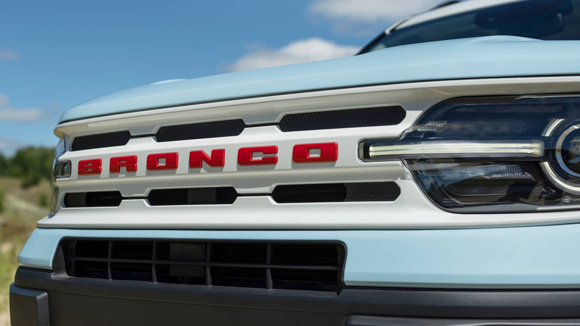 Bronco Heritage Edition available winter 2023. Limited availability. Preproduction models shown.  Always consult the Owner’s Manual before off-road driving, know your terrain and trail difficulty, and use appropriate safety gear.