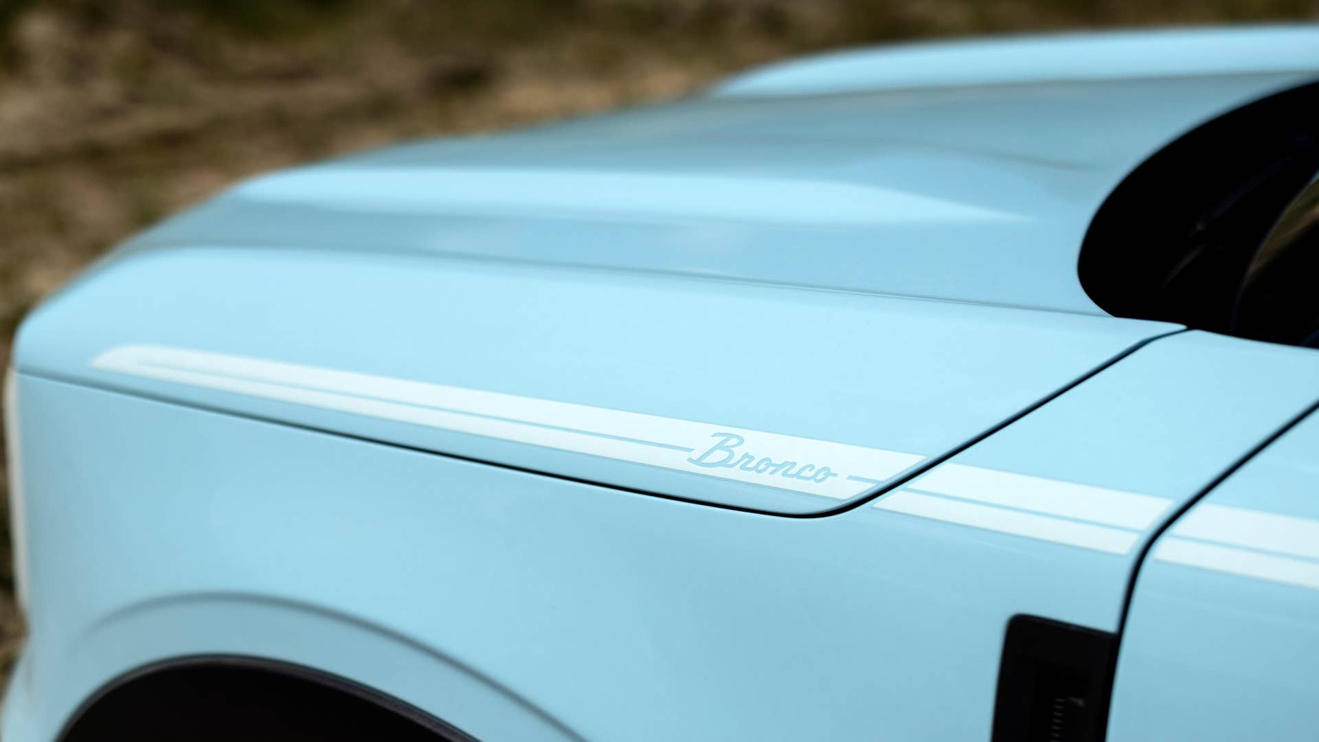 Bronco Heritage Edition available winter 2023. Limited availability. Preproduction models shown.  Always consult the Owner’s Manual before off-road driving, know your terrain and trail difficulty, and use appropriate safety gear.