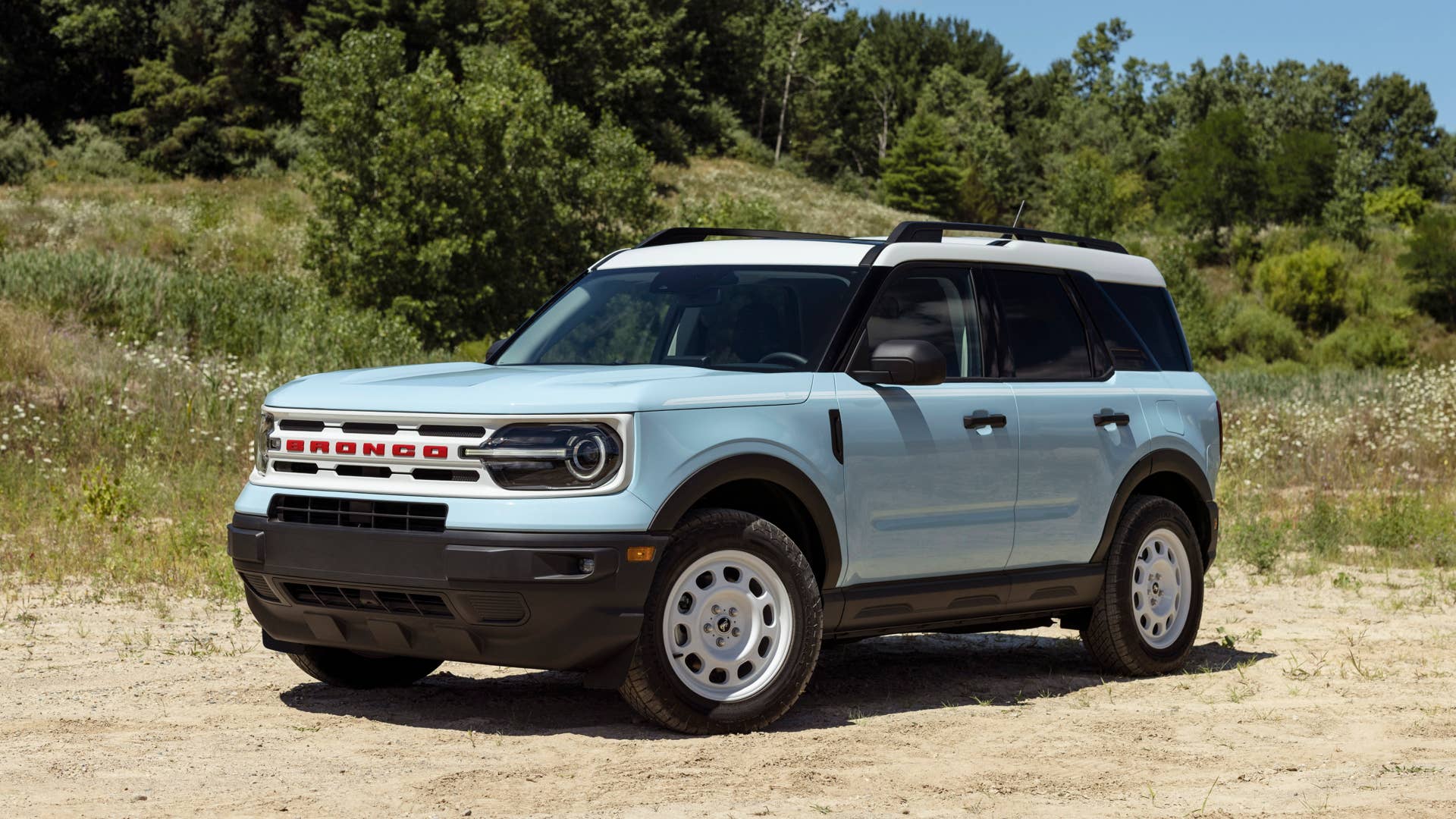 Bronco Heritage Edition available winter 2023. Limited availability. Preproduction models shown.  Always consult the Owner’s Manual before off-road driving, know your terrain and trail difficulty, and use appropriate safety gear.