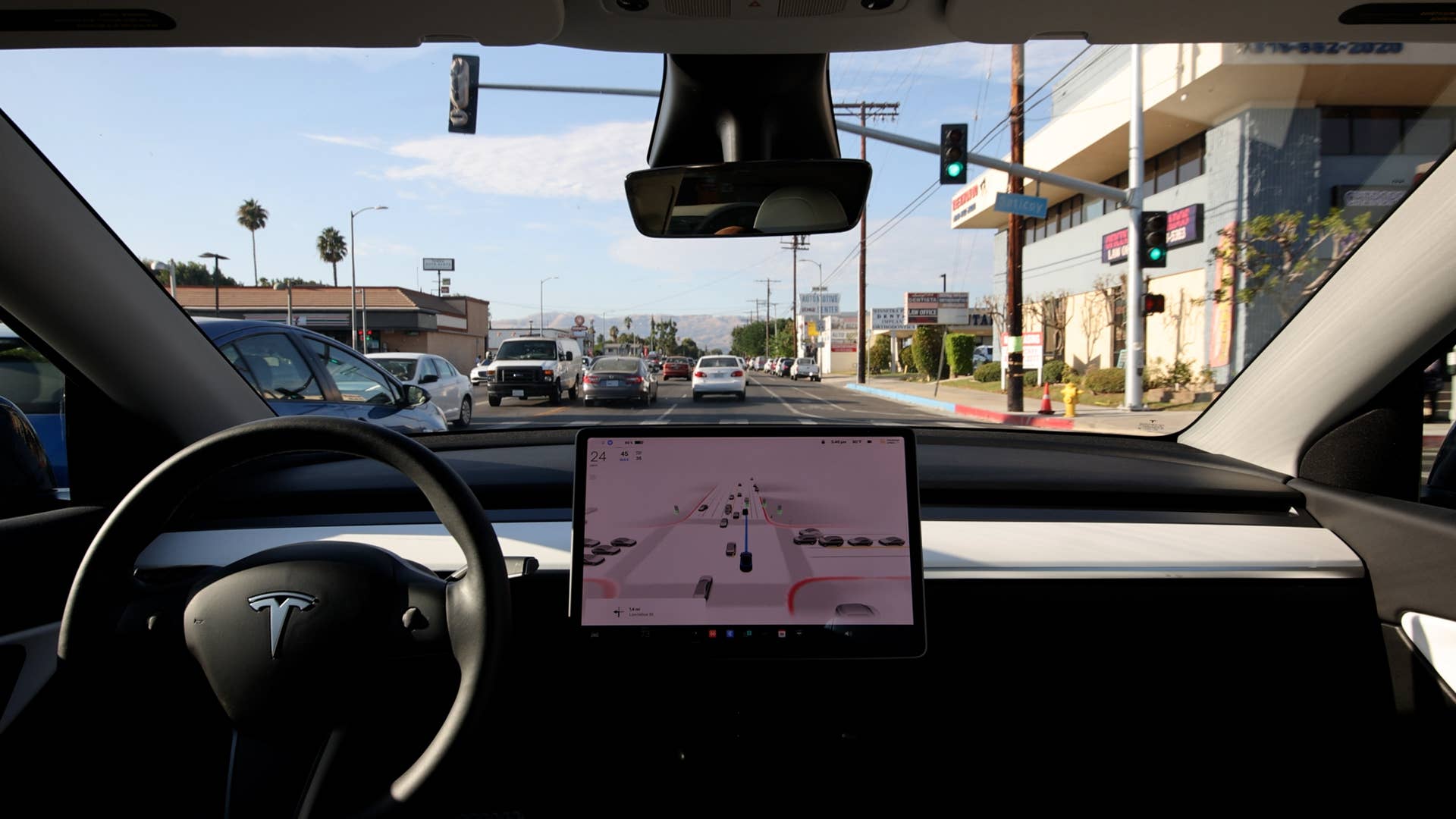 LOS ANGELES - AUG 22: Tesla Model Y driven by the Full Self Driving Beta in moderate traffic in an L.A. suburb. The autonomous driving system relies primarily on cameras without the use of LIDAR.