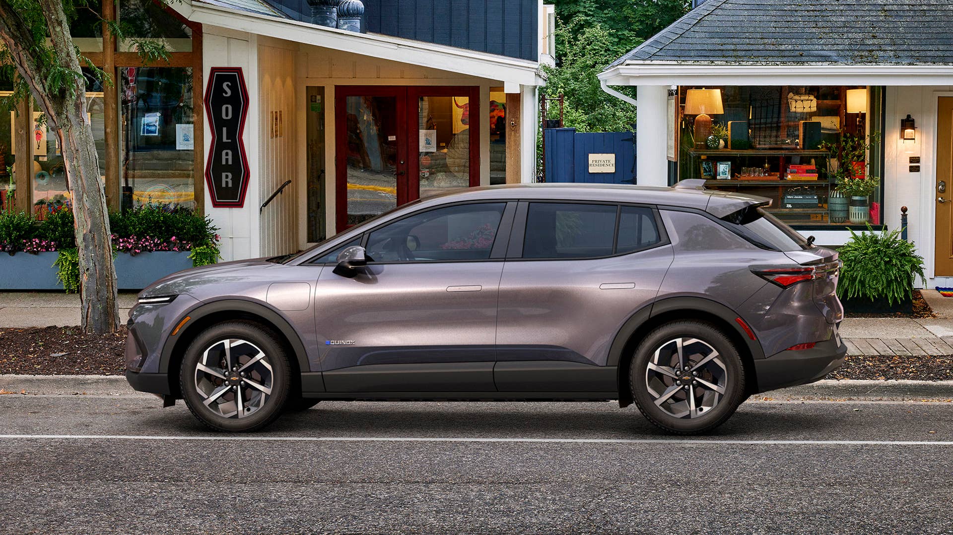 Driver’s side view of 2024 Chevrolet Equinox EV 1LT in Galaxy Gray Metallic parked on a street. Preproduction model shown. Actual production model may vary. 2024 Chevrolet Equinox EV available Fall 2023.
