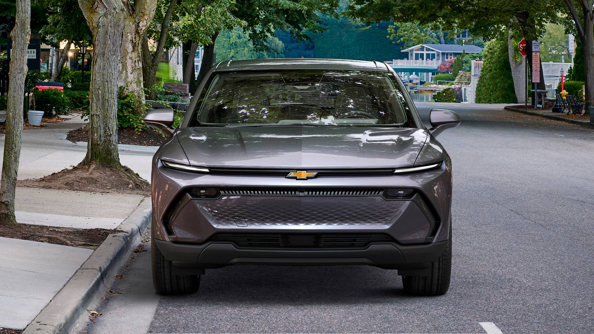 Front view of 2024 Chevrolet Equinox EV 1LT in Galaxy Gray Metallic parked on a street. Preproduction model shown. Actual production model may vary. 2024 Chevrolet Equinox EV available Fall 2023.