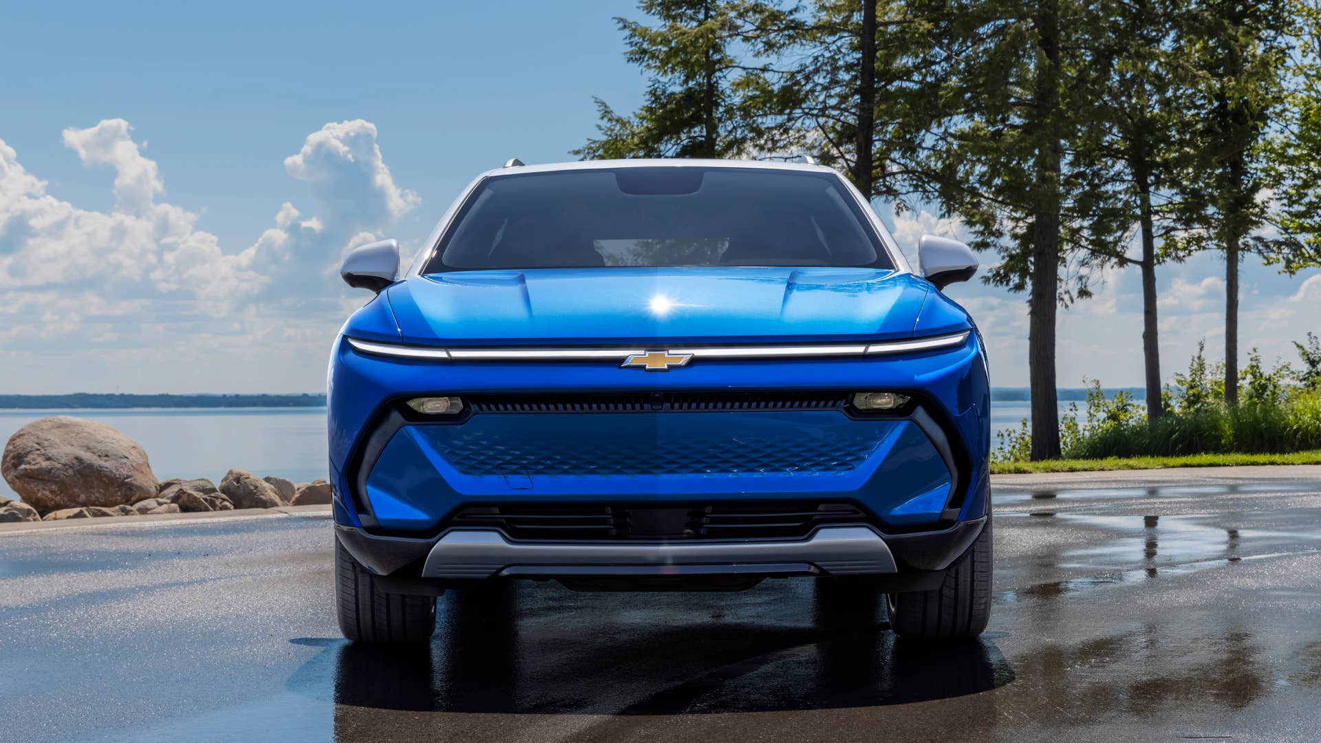 Front view of 2024 Chevrolet Equinox EV 3LT in Riptide Blue parked in front of a lake. Preproduction model shown. Actual production model may vary. 2024 Chevrolet Equinox EV available Fall 2023.