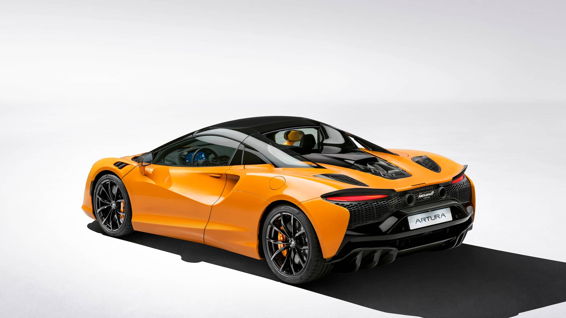 2025 McLaren Artura Spider roof up rear angled view
