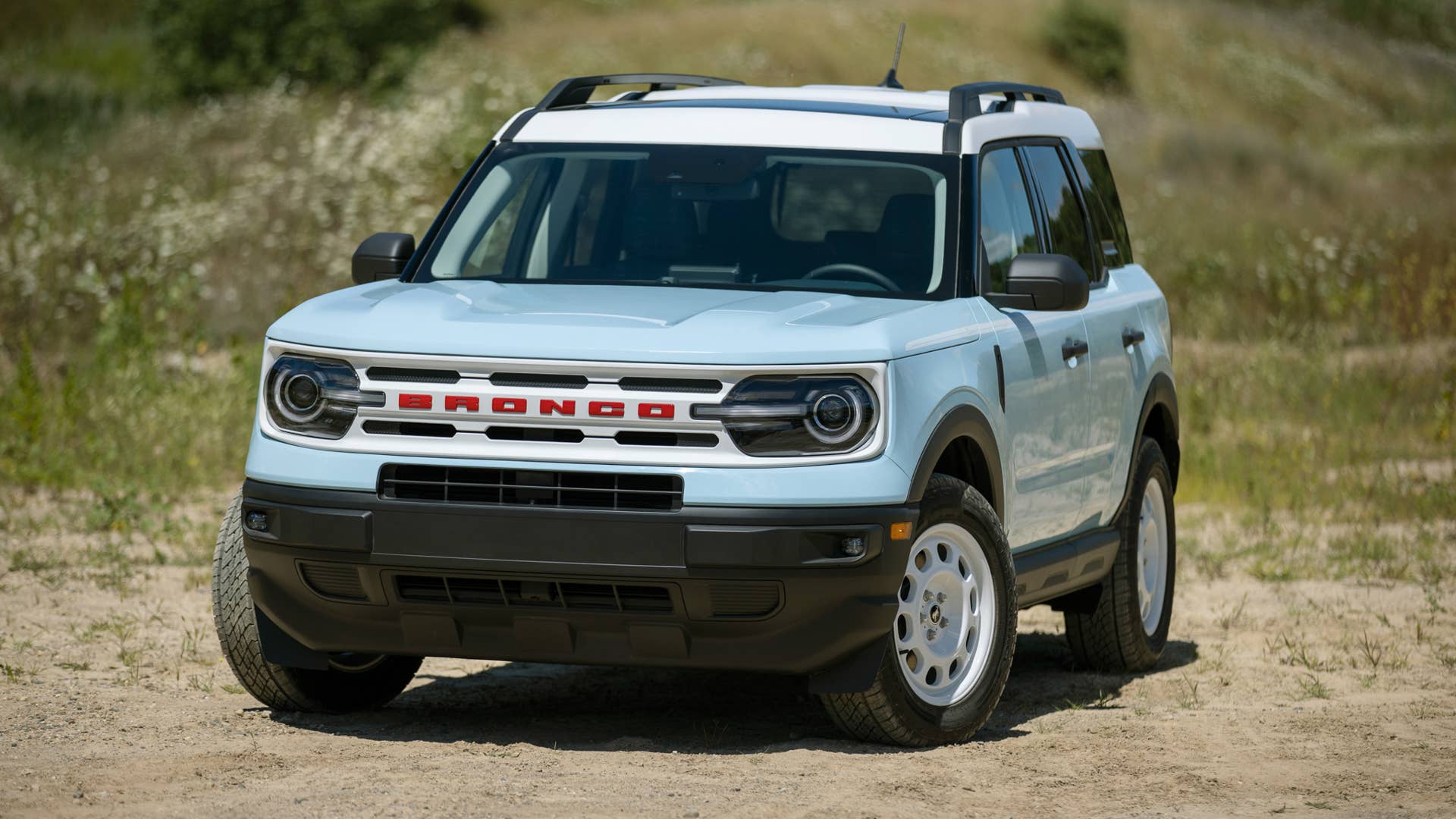 Bronco Heritage Edition available winter 2023. Limited availability. Preproduction models shown.  Always consult the Owner’s Manual before off-road driving, know your terrain and trail difficulty, and use appropriate safety gear.