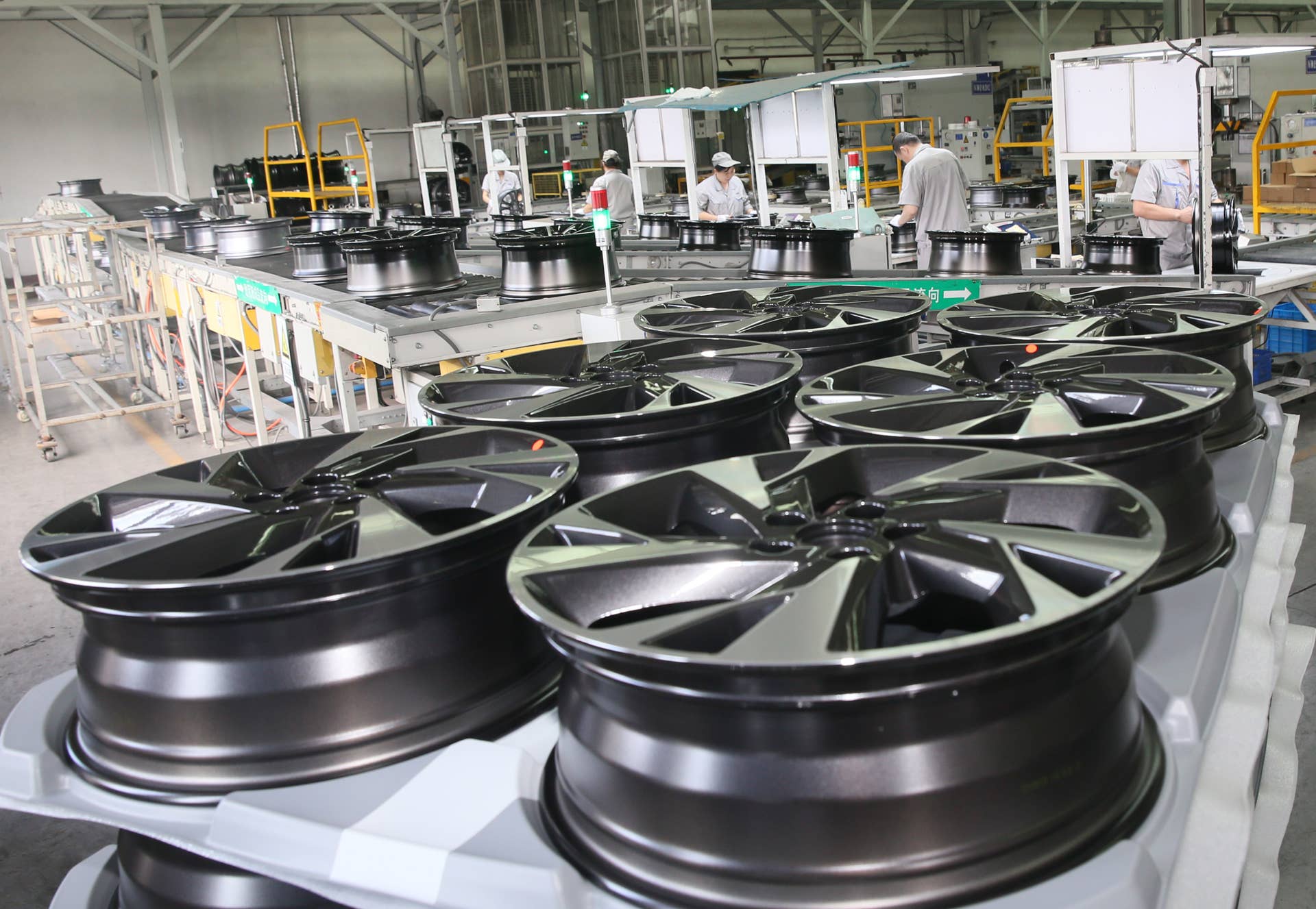 SANMENXIA, CHINA - AUGUST 19: Employees work on the production line of Sanmenxia's Dicastal Wheel Manufacture Co., Ltd. on August 19, 2021 in Sanmenxia, Henan Province of China. (Photo by Sun Meng/VCG via Getty Images)