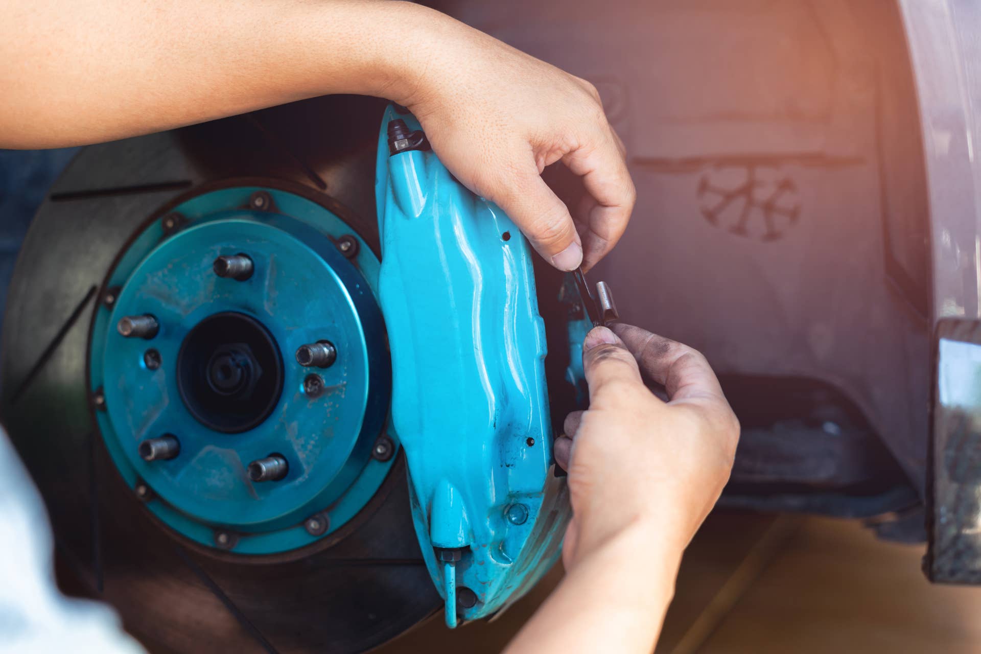 Technician check brake calipers are inspected of car adjust brake pad and check thickness, Check the brake fluid and equipment malfunction ,car service concept and mainternance