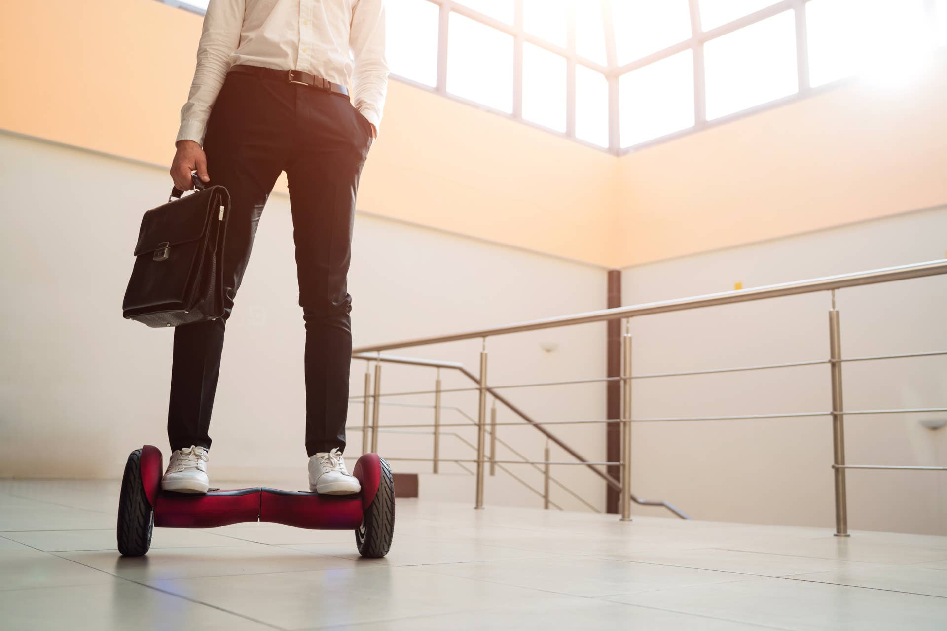 Young businessman is riding a gyroboard