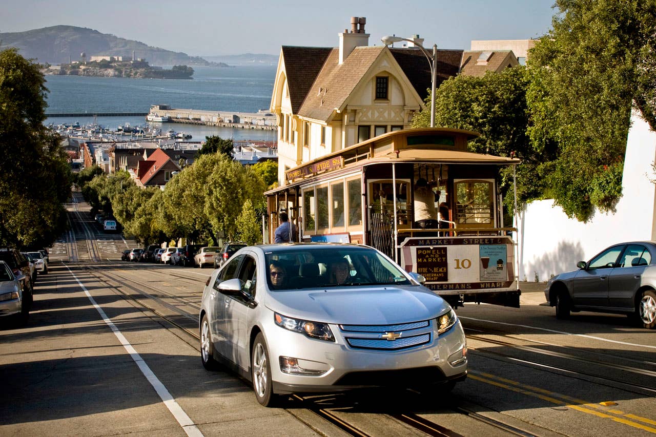 A pre-production Chevrolet Volt passes a trolley while navigating the steep climbs of the San Francisco Bay area while on an engineering development drive Saturday, April 25, 2010 in San Francisco, California The Volt will be available in California during the last quarter of 2010. (Photo by Martin Klimek for Chevrolet)