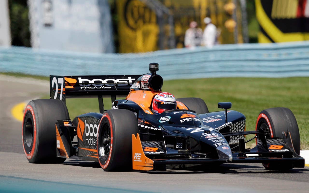Adam Carroll of Northern Ireland drives his race car during qualifying Saturday, July 3, 2010, for the IndyCar Series' Watkins Glen Camping World Grand Prix at The Glen in Watkins Glen, N.Y. Carroll qualified 10th for Sunday's race, his  first IRL race. (AP Photo/Mel Evans)