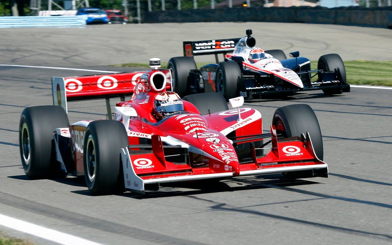Scott Dixon of New Zealand drives his race car past Will Power of Australia Saturday, July 3, 2010, during practice during practice for the IndyCar Series'  Watkins Glen Camping World Grand Prix at the Glen in Watkins Glen, N.Y. for , N.Y. (AP Photo/Mel Evans)