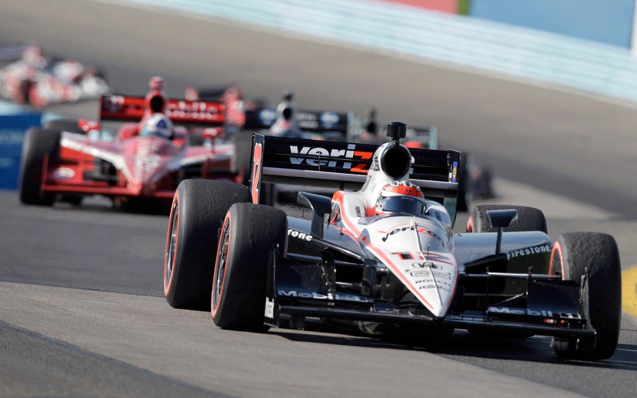 Will Power of Australia leads a pack of racers through the S-curves on his way to winning the IndyCar Series' Watkins Glen Camping World Grand Prix at The Glen in Watkins Glen, N.Y., Sunday, July 4, 2010. Ryran Briscoe of Australia finished second. (AP Photo/Mel Evans)