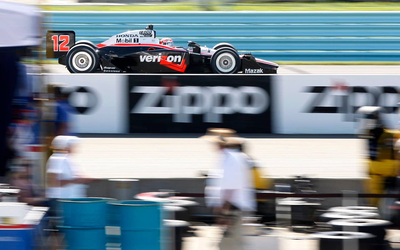 Will Power of Australia races past the pits on his way to winning the IndyCar Series' Watkins Glen Camping World Grand Prix at The Glen in Watkins Glen, N.Y., Sunday, July 4, 2010. Ryran Briscoe of Australia finished second. (AP Photo/Mel Evans)