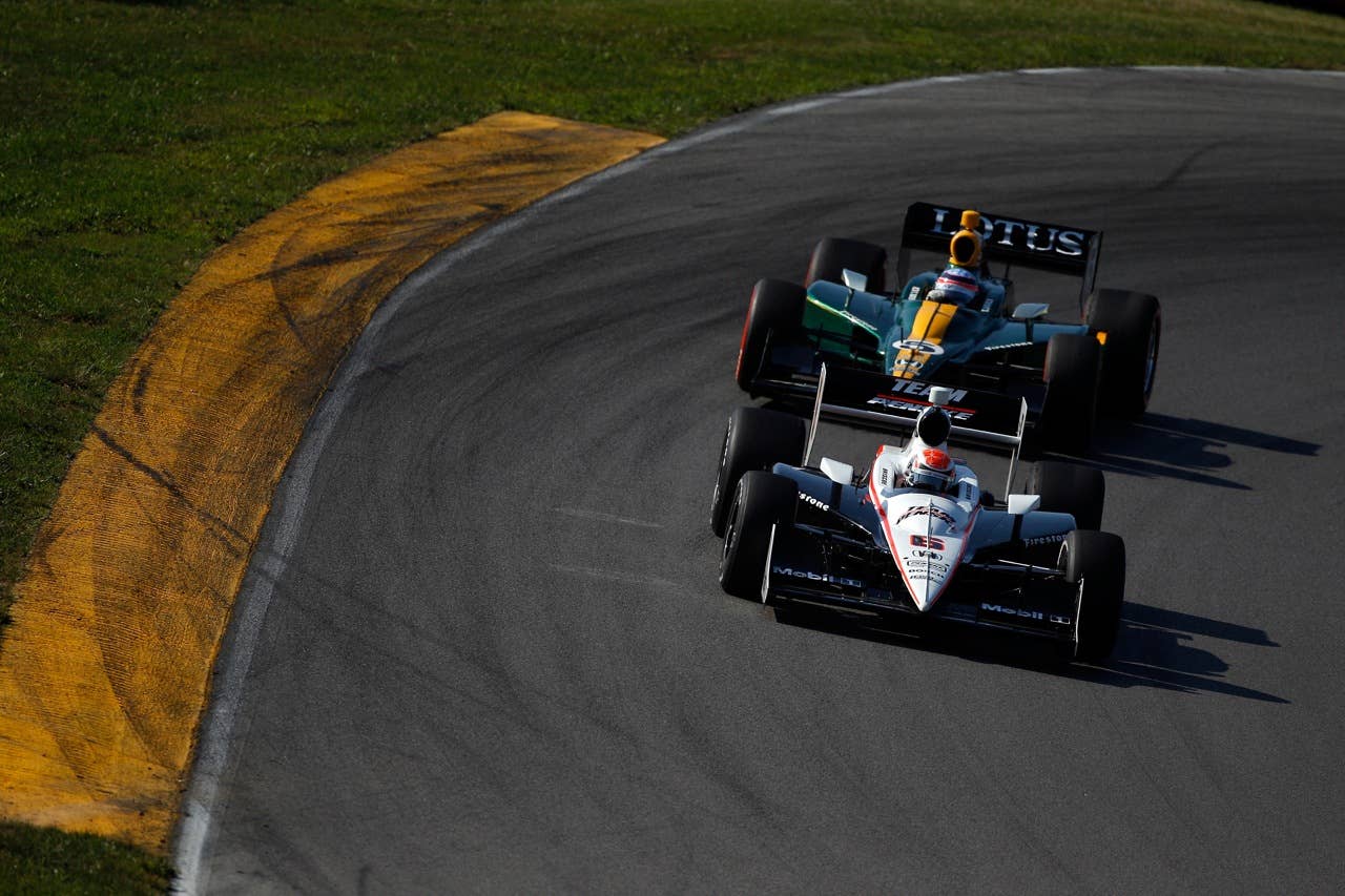 LEXINGTON, OH - AUGUST 08:  Ryan Briscoe of Australia, driver of the #6 Team Penske Dallara Honda leads Takuma Sato of Japan, driver of the #5 Lotus-KV Racing Technology Dallara Honda during the IZOD IndyCar Series Honda Indy 200 on August 8, 2010 in Lexington, Ohio.  (Photo by Chris Graythen/Getty Images)