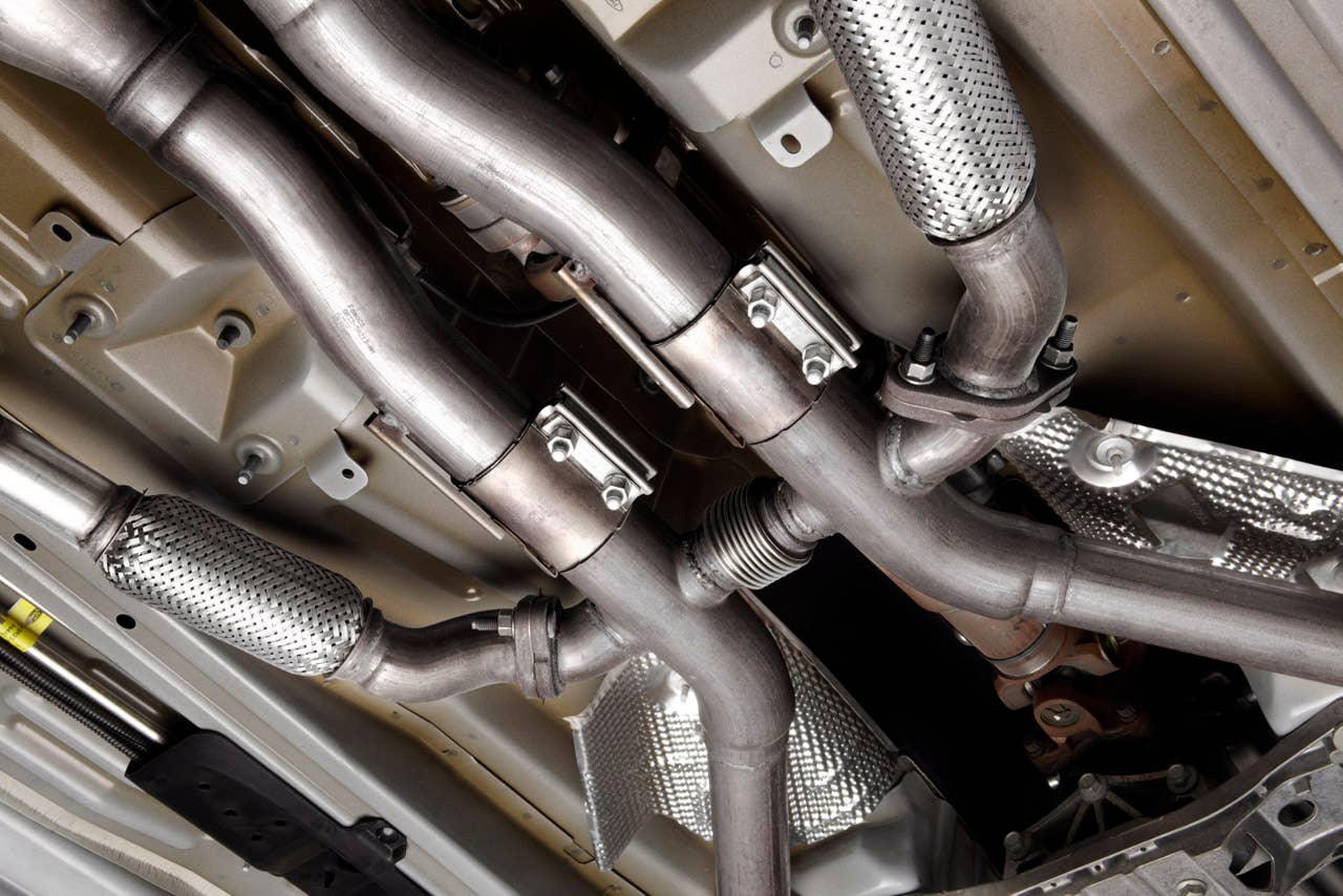2012 Ford Mustang Boss 302: A quad-pipe exhaust system, including subtle side pipes, helps envelop 2012 Boss and Laguna Seca drivers in full V8 sound. (08/13/2010)