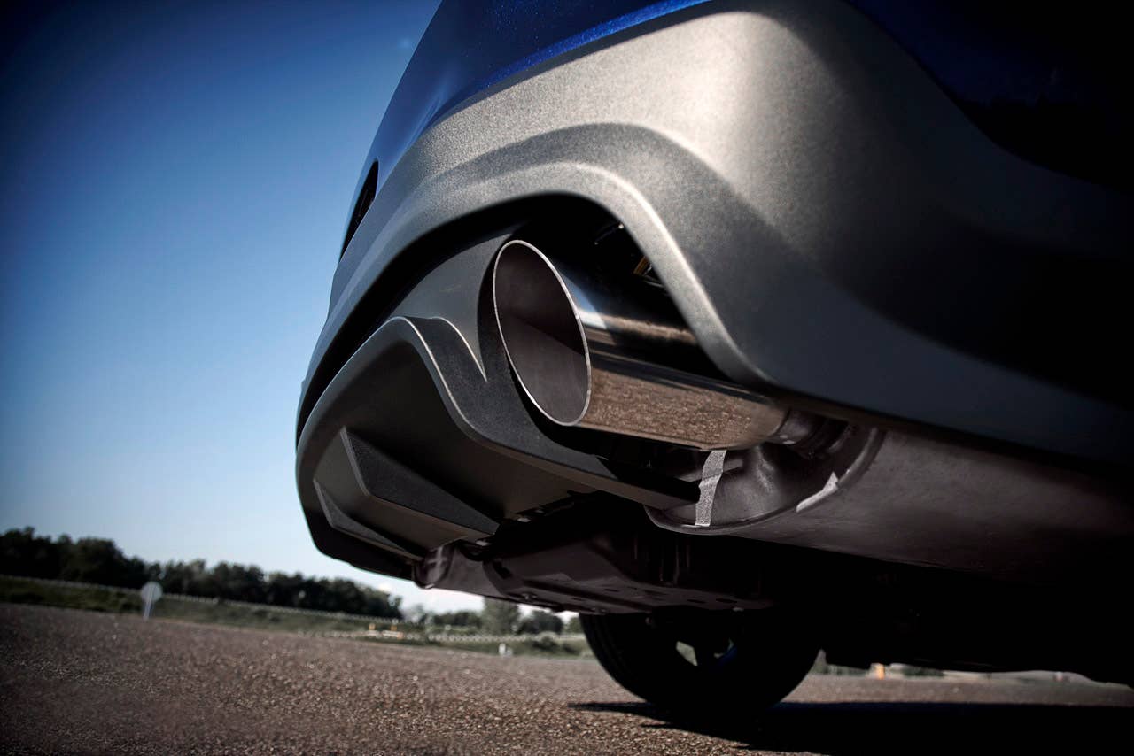 2012 Ford Mustang Boss 302: A quad-pipe exhaust system, including subtle side pipes, helps envelop 2012 Boss and Laguna Seca drivers in full V8 sound. (08/13/2010)