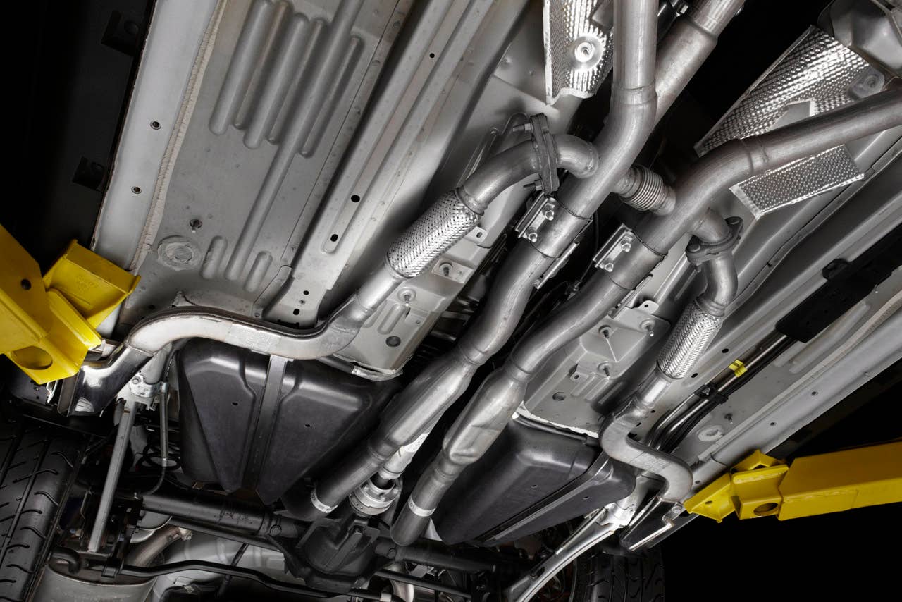 2012 Ford Mustang Boss 302: A quad-pipe exhaust system, including subtle side pipes, helps envelop 2012 Boss and Laguna Seca drivers in full V8 sound. (08/13/2010)