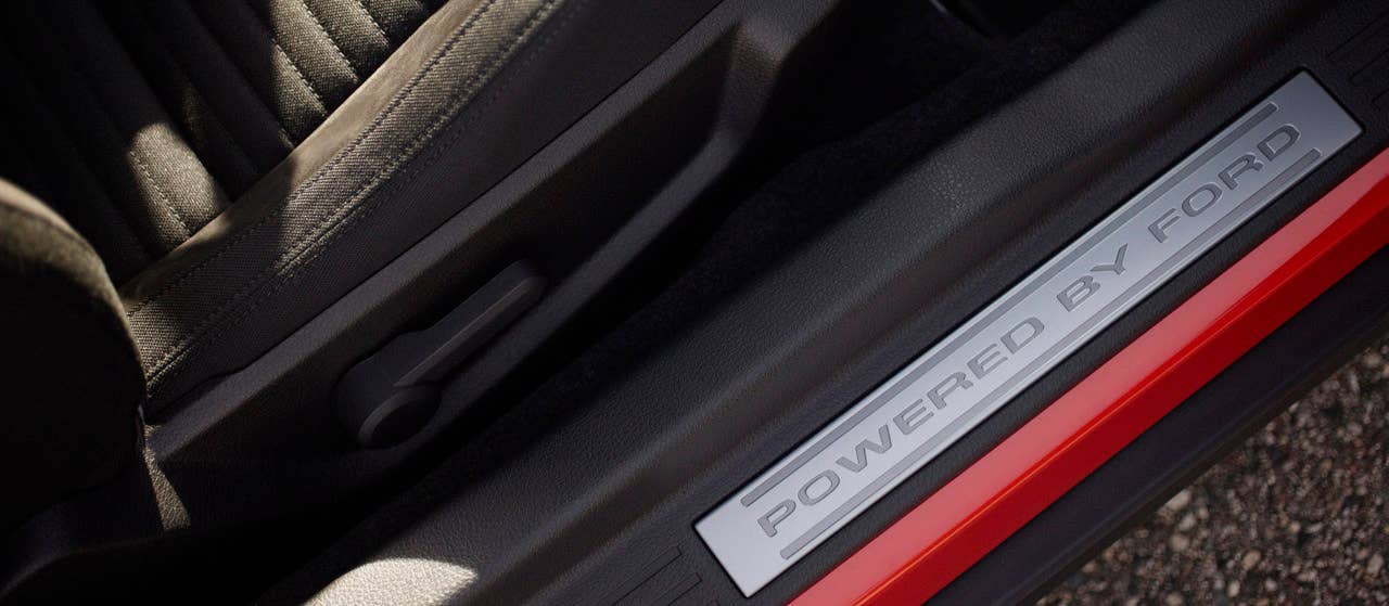 2012 Ford Mustang Boss 302: 'Powered by Ford' door sill plates remind Boss 302 and Laguna Seca drivers they're in a special car. (08/13/2010)