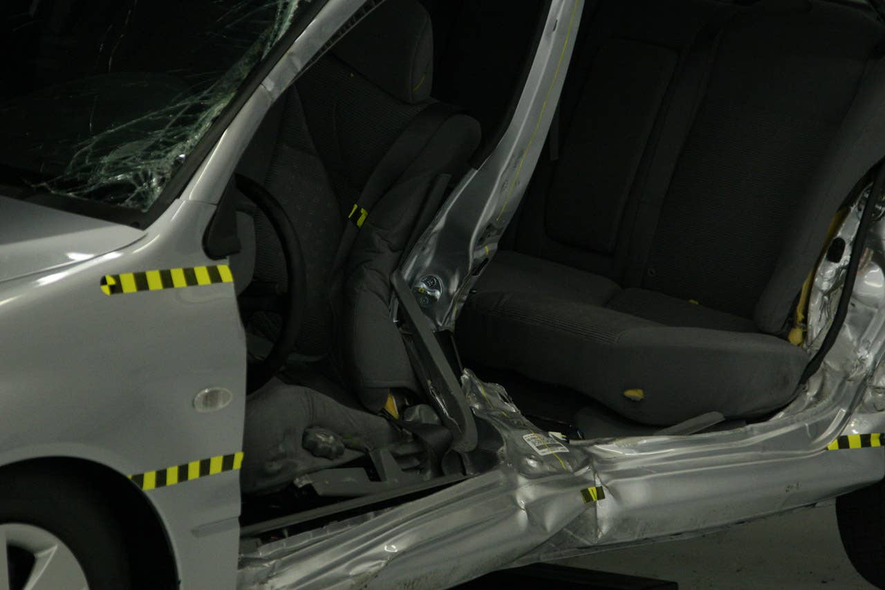 Broken B-pillar in a 2005 Mitsubishi Lancer after 31 mph impact