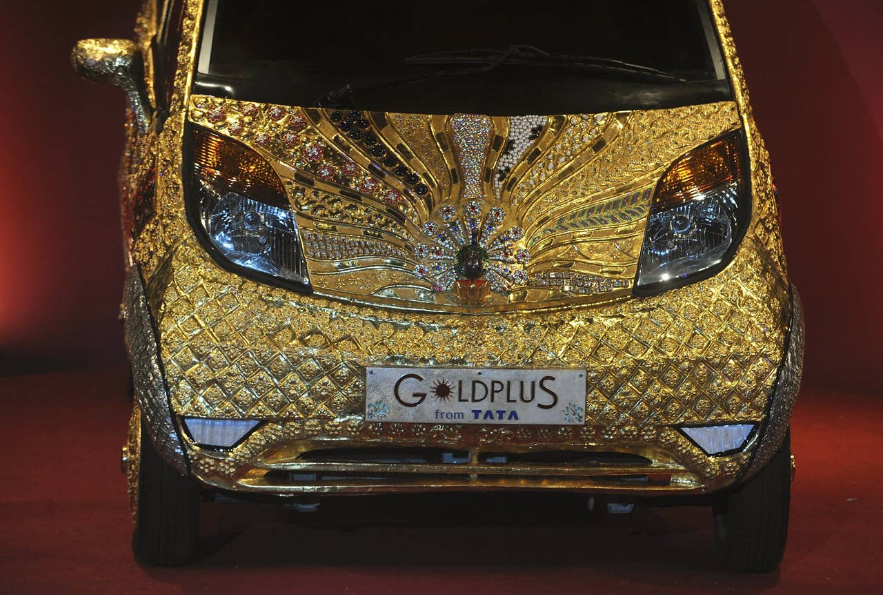 A custom Tata Motors' 'Nano' car, is seen adorned in gold, silver and gemstone trimmings during its unveiling in Mumbai on September 19, 2011. The World's first Gold jewellery car, claimed by Tata, is made from 80 kilograms of 22 karat gold, 15 kilograms of silver, and numerous gemstones. AFP PHOTO/ Punit PARANJPE (Photo credit should read PUNIT PARANJPE/AFP/Getty Images)