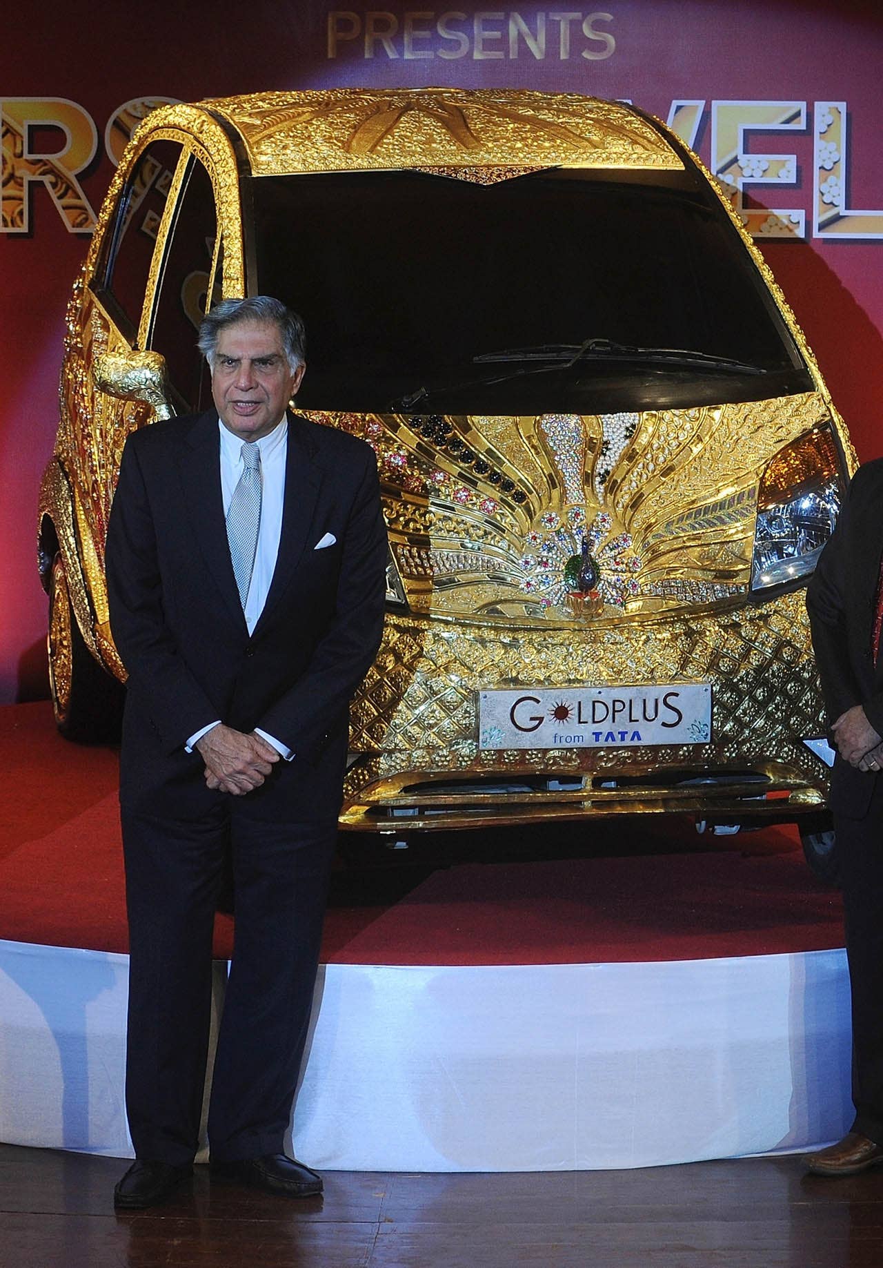 Tata Group chairman Ratan Tata stands next to a custom Tata Motors' 'Nano' car, seen adorned in gold, silver and gemstone trimmings, during its unveiling in Mumbai on September 19, 2011. The World's first Gold jewellery car, claimed by Tata, is made from 80 kilograms of 22 karat gold, 15 kilograms of silver, and numerous gemstones. AFP PHOTO/ Punit PARANJPE (Photo credit should read PUNIT PARANJPE/AFP/Getty Images)