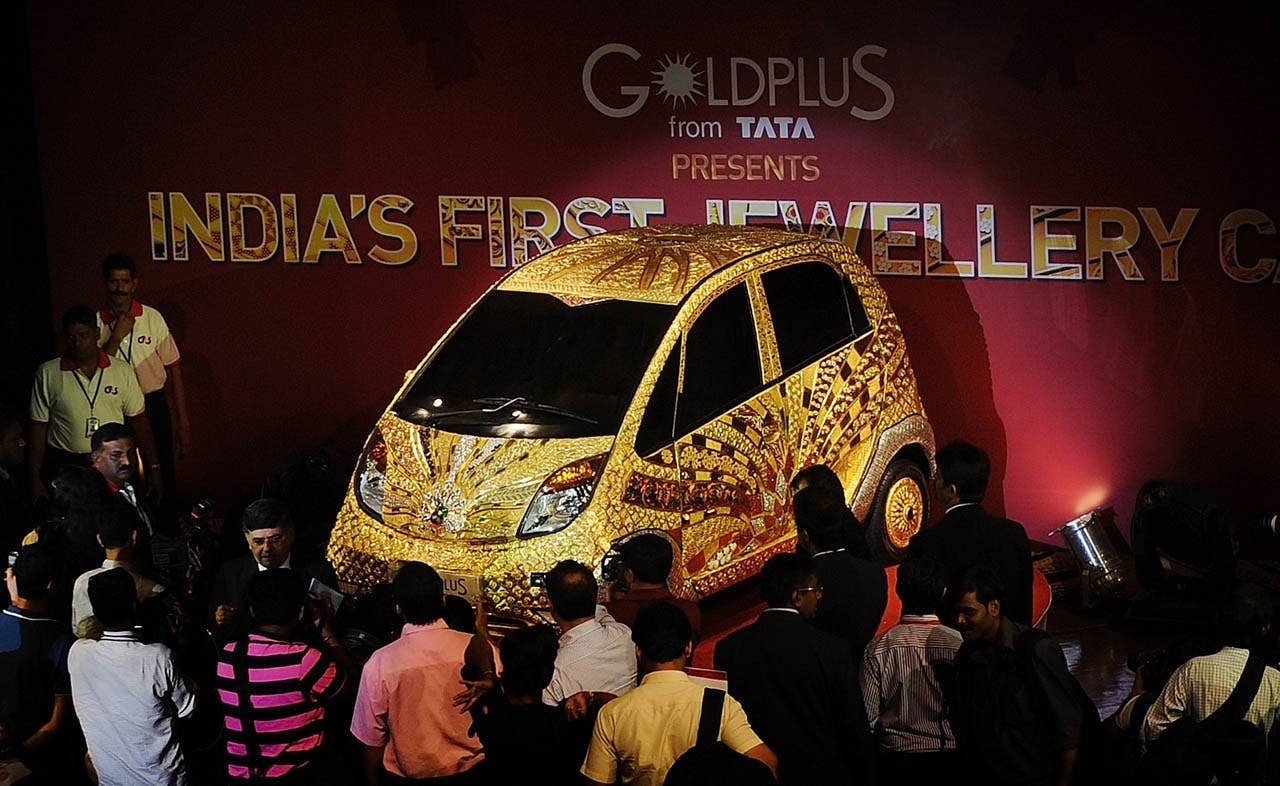 A custom Tata Motors' 'Nano' car, is seen adorned in gold, silver and gemstone trimmings during its unveiling in Mumbai on September 19, 2011. The World's first Gold jewellery car, claimed by Tata, is made from 80 kilograms of 22 karat gold, 15 kilograms of silver, and numerous gemstones. AFP PHOTO/ Punit PARANJPE (Photo credit should read PUNIT PARANJPE/AFP/Getty Images)