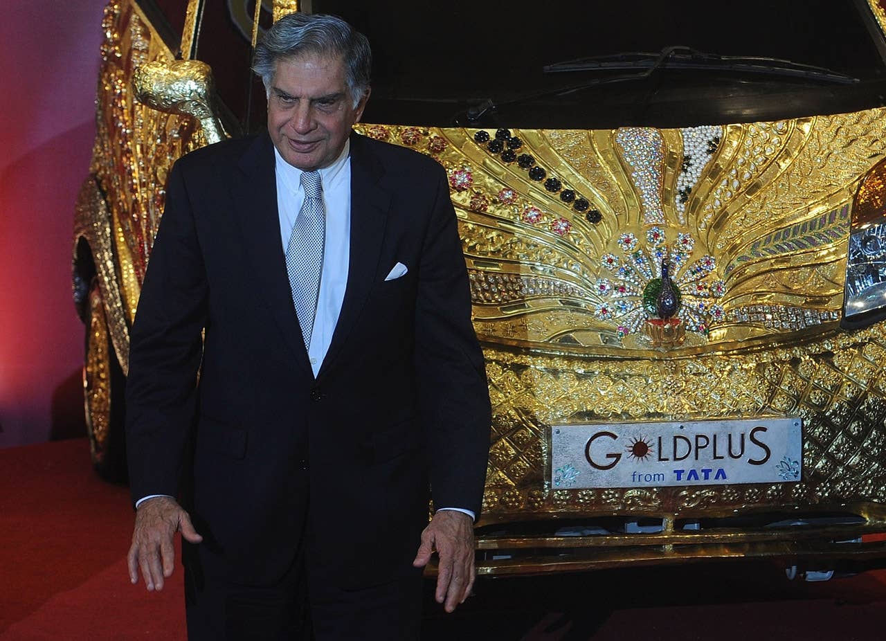 Ratan Tata, chairman of Tata Group, stands next to a custom Tata Motors' 'Nano' car, seen adorned in gold, silver and gemstone trimmings, during its unveiling in Mumbai on September 19, 2011. The World's first Gold jewellery car, claimed by Tata, is made from 80 kilograms of 22 karat gold, 15 kilograms of silver, and numerous gemstones. AFP PHOTO/ Punit PARANJPE (Photo credit should read PUNIT PARANJPE/AFP/Getty Images)