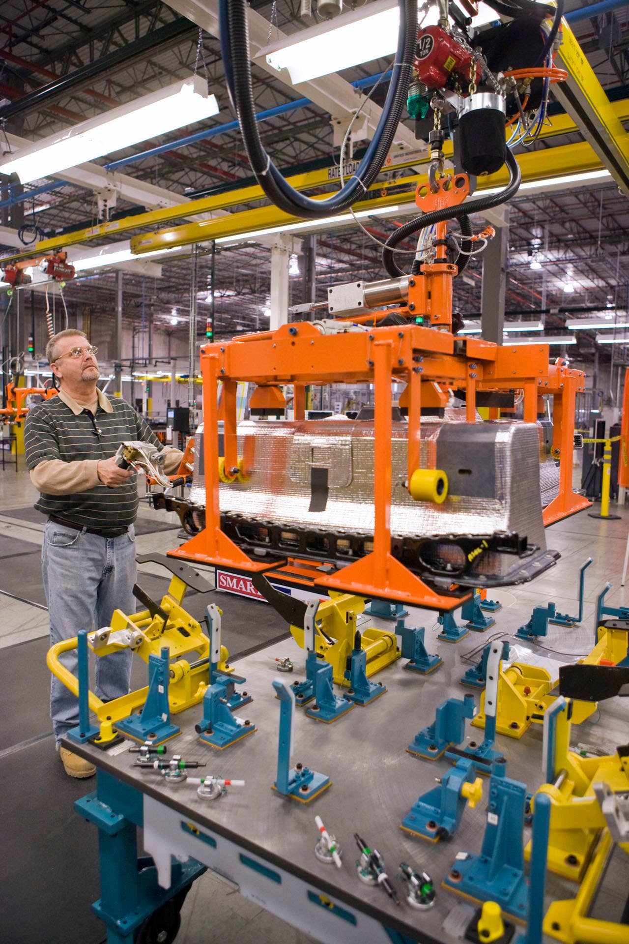 The first Chevrolet Volt battery built at the General Motors Brownstown Battery plant undergoes a dimensional quality check in Brownstown Township, Michigan Tuesday, December 22, 2009. The Brownstown facility is the first lithium ion battery pack manufacturing plant in the U.S. operated by a major automaker. (Photo by Jeffrey Sauger for General Motors)