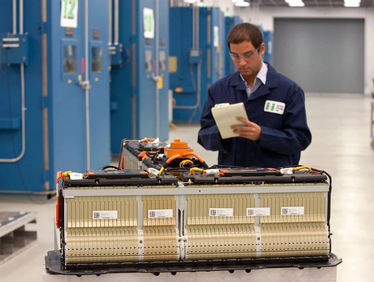 A battery engineer checks a Chevrolet Volt battery at the General Motors Global Battery Systems Lab in Warren, Michigan Wednesday, June 30, 2010. The Chevrolet Volt will offer customers an unprecedented standard 8 year/100,000 mile warranty on its lithium-ion battery. GM engineers have completed more than 1 million miles and 4 million hours of validation battery testing since 2007. Each Volt battery pack has nine modules and 288 cells. GM designed and engineered 99 percent of the 155 components in each battery. (Photo by John F. Martin for Chevrolet)