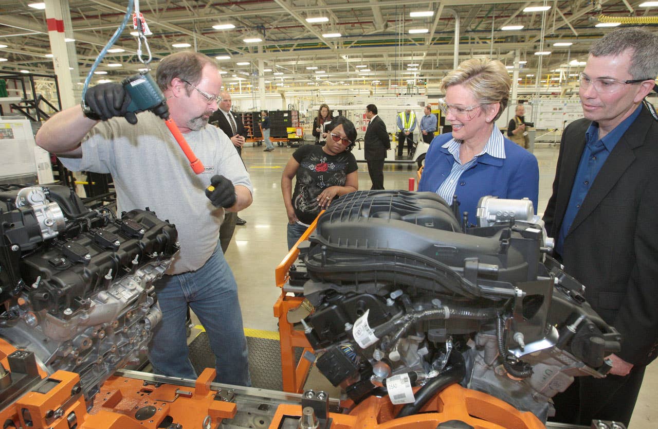 Trenton  March 19, 2010  Don DeKeyser, Head of Trenton South Engine Plant, right, shows Chrysler Group LLC's all-new engine plant to Michigan Governor Jennifer Granholm, center, during a celebration event at the facility today.  Trenton South Engine Plant is the first engine manufacturing facility to receive LEED Gold certification and demonstrates Chrysler's dedication to the environment and surrounding communities.  The plant will produce the all-new Pentastar V-6 engine which improves flexibility and fuel efficiency for future Chrysler vehicles.  Trenton South Engine Plant Assembler Joe Simon, left, checks oil levels and removes head ID bolts.  (Joe Wilssens photo) For more information contact Jodi Tinson at 248-512-2944.