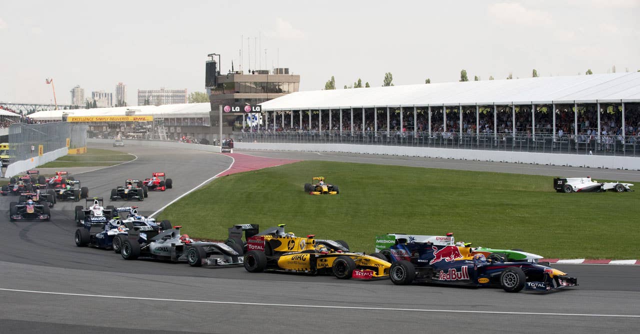 The field takes a turn as Renault driver Vitaly Petrov of Russia (top C) and BMW Sauber driver Pedro de la Rosa of Spain(Top-R) cut through the grass during the Canadian Formula One Grand Prix June 123, 2010 in Montreal. AFP PHOTO/DON EMMERT (Photo credit should read DON EMMERT/AFP/Getty Images)