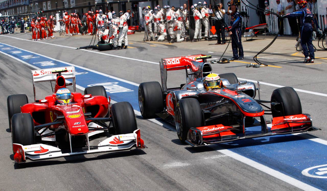 McLaren Mercedes' Lewis Hamilton, right, of Britain, and Ferrari's Fernando Alonso, of Spain, drive side-by-side out of the pits during the Canadian Grand Prix auto race, Sunday, June 13, 2010, in Montreal. Hamilton won the race while Alonso placed third. (AP Photo/The Canadian Press,Paul Chiasson)