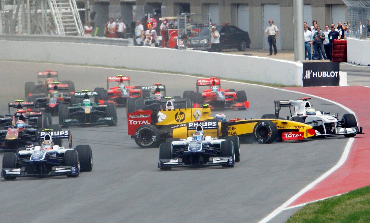 Renault driver Vitaly Petrov (yellow car), of Russia, collides with BMW Sauber driver Pedro de la Rosa, of Spain, at the start of the the Canadian Grand Prix, Sunday, June 13, 2010, in Montreal. (AP Photo/The Canadian Press,Ryan Remiorz)