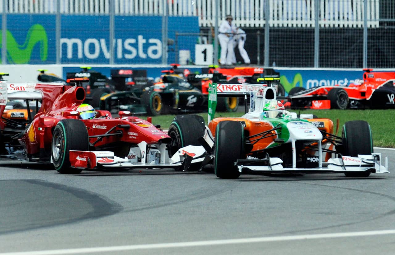Ferrari driver Felipe Massa, left, of Brazil, collides with Force India driver Adrian Sutil , right, of Germany, at the start of the the Canadian Grand Prix auti race Sunday, June 13, 2010, in Montreal. (AP Photo/The Canadian Press,Graham Hughes)