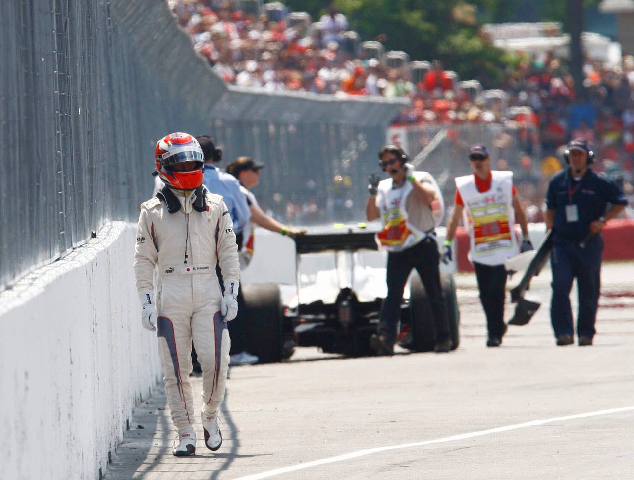 BMW Sauber driver Kamui Kobayashi, of Japan, walks away from his car following an accident during the Canadian Grand Prix auto race Sunday, June 13, 2010, in Montreal. (AP Photo/The Canadian Press, Paul Chiasson)