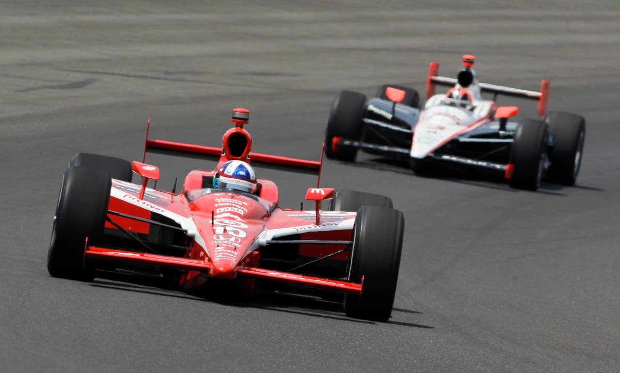 Dario Franchitti, of Scotland, leads Helio Castroneves, of Brazil, early in the race during the Indianapolis 500 auto race at the Indianapolis Motor Speedway in Indianapolis, Sunday, May 30, 2010. (AP Photo/Tom Strattman)