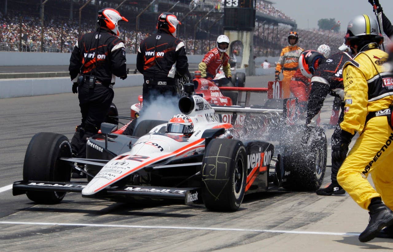 The fueling connector is ripped away as Will Power, of Australia, leaves the pits on the 38th lap during the Indianapolis 500 auto race at the Indianapolis Motor Speedway in Indianapolis, Sunday, May 30, 2010. (AP Photo/Darron Cummings)