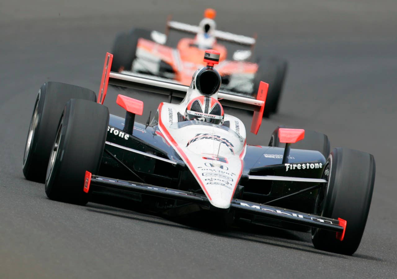Pole sitter Helio Castroneves, of Brazil, races through the first turn during the final practice session for the Indianapolis 500 auto race at the Indianapolis Motor Speedway in Indianapolis, Friday, May 28, 2010. The race will be run Sunday. (AP Photo/Tom Strattman)