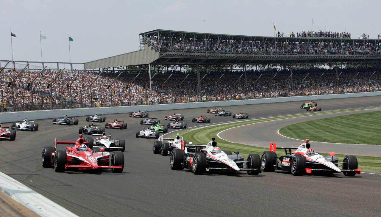 Helio Castroneves, right, of Brazil, Will Power, center, of Australia, and Dario Franchitti, of Scotland, lead the field at the start of the Indianapolis 500 auto race at the Indianapolis Motor Speedway in Indianapolis, Sunday, May 30, 2010. (AP Photo/Tom Strattman)