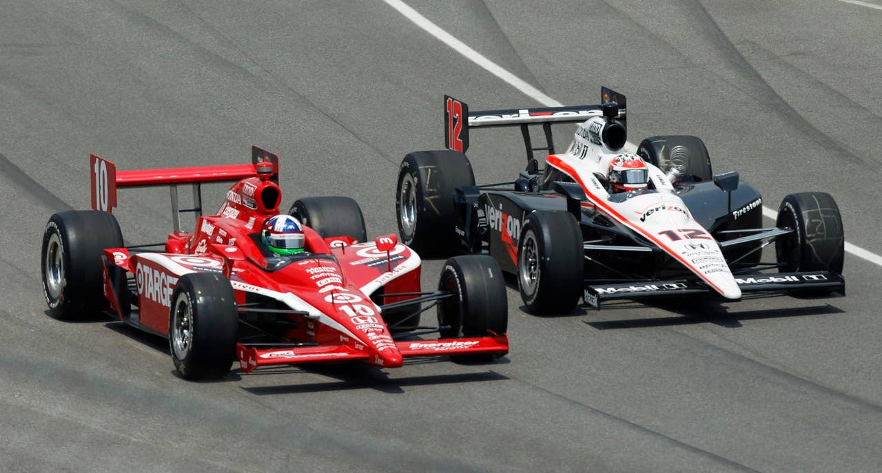 Dario Franchitti, left, of Scotland, and Will Power, of Australia, head into a turn during Indianapolis 500 auto race at Indianapolis Motor Speedway in Indianapolis, Sunday, May 30, 2010. (AP Photo/Mike Groll)