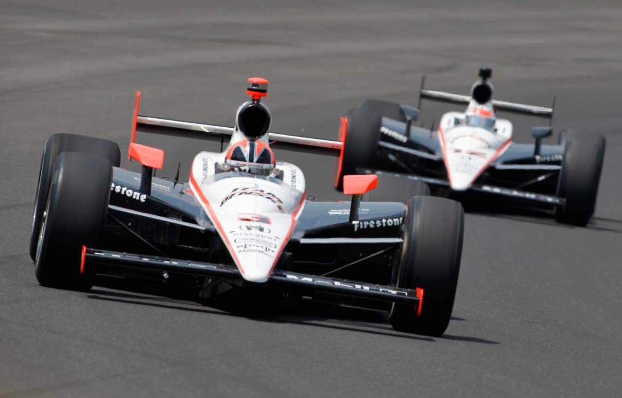 Helio Castroneves, of Brazil, leads Will Power, of Australia, early in he race during the Indianapolis 500 auto race at the Indianapolis Motor Speedway in Indianapolis, Sunday, May 30, 2010. (AP Photo/Tom Strattman)