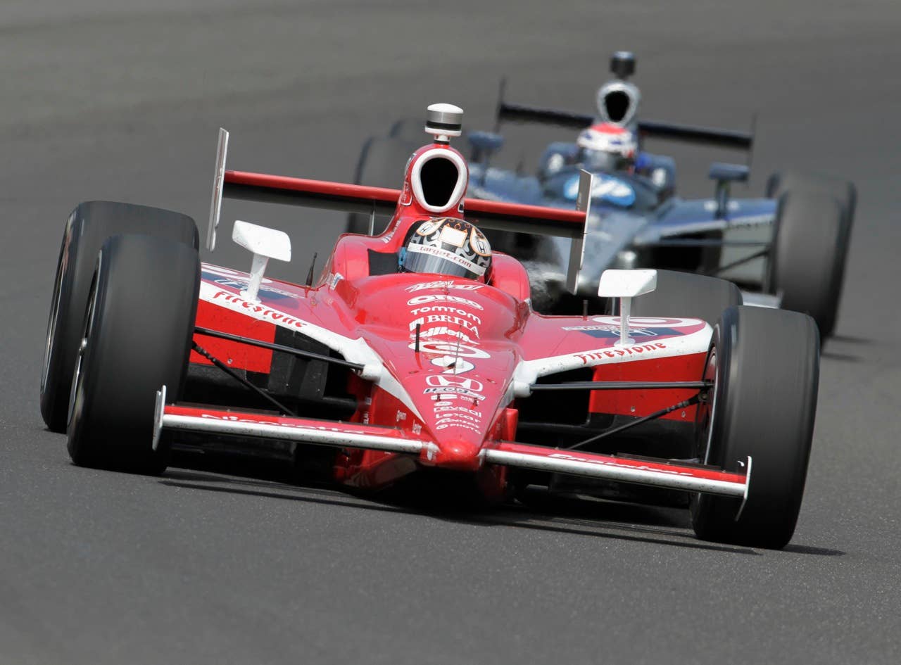 Scott Dixon, of New Zealand, races through the first turn on the final day of practice for the Indianapolis 500 auto race at the Indianapolis Motor Speedway in Indianapolis, Friday, May  28, 2010. The race will be run Sunday. (AP Photo/Tom Strattman)