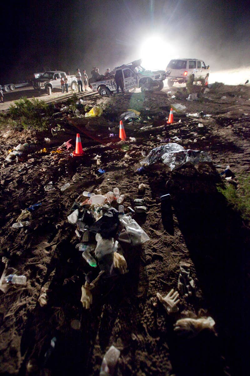 Debris from the scene of an accident litters the ground Sunday, Aug. 15, 2010 where an off-road race truck, background, went out of control and ran into a crowd of spectators during a race in Lucerne Valley, Calif., on Saturday. At least eight people were killed and 12 wounded during the incident about 100 miles east of Los Angeles. (AP Photo/Francis Specker)