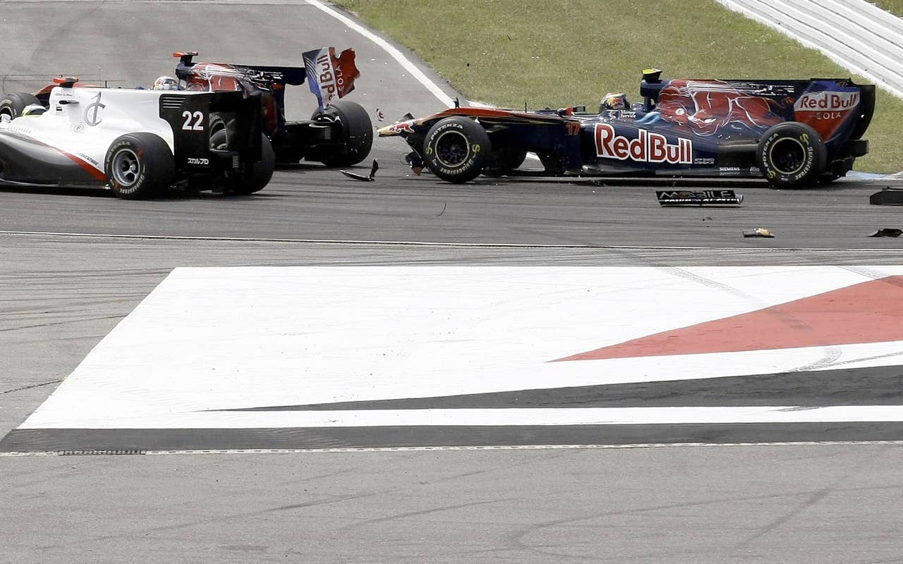 Toro Rosso's Spanish driver Jaime Alguersuari (R) crashes into his Swiss team mate Sebastien Buemi at the Hockenheimring circuit on July 25, 2010 in Hockenheim, during the Formula One German Grand Prix.            AFP PHOTO / GUILLAUME BAPTISTE (Photo credit should read GUILLAUME BAPTISTE/AFP/Getty Images)