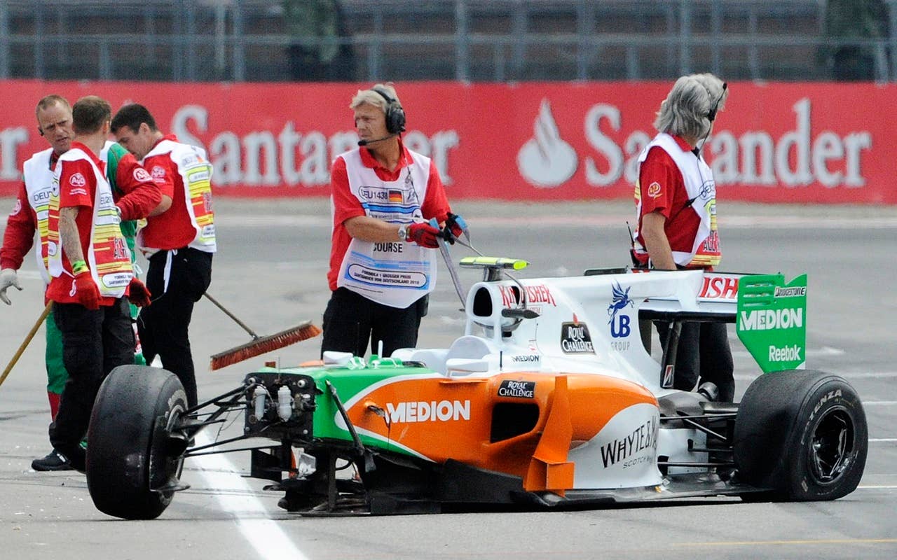 The car of Force-India Formula One driver Vitantonio Liuzzi of Italy stands at the track after crashing during the qualifying at the race track in Hockenheim, Germany, Saturday, July 24, 2010. The German Grand Prix will  take place on  Sunday, July 25, 2010. (AP Photo/Jens Meyer/)