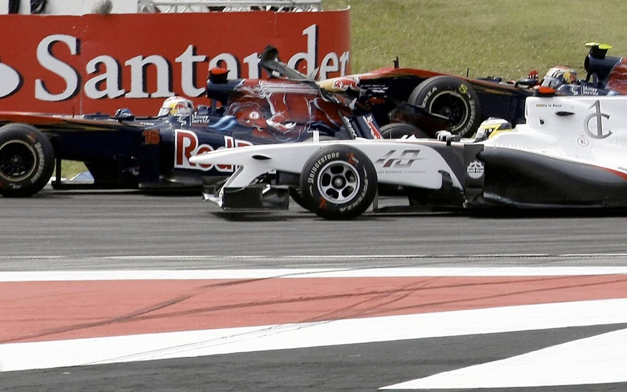 Toro Rosso's Spanish driver Jaime Alguersuari (R) crashes into his Swiss team mate Sebastien Buemi at the Hockenheimring circuit on July 25, 2010 in Hockenheim, during the Formula One German Grand Prix.            AFP PHOTO / GUILLAUME BAPTISTE (Photo credit should read GUILLAUME BAPTISTE/AFP/Getty Images)