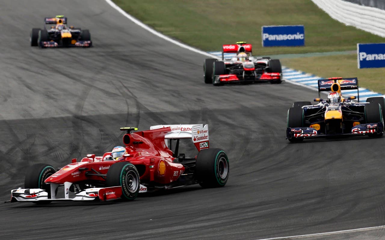 Ferrari's Spanish Fernando Alonso drives ahead of Red Bull's German Sebastian Vettel and McLaren Mercedes' British  Lewis Hamilton at the Hockenheimring circuit on July 25, 2010 in Hockenheim, during the Formula One German Grand Prix.             AFP PHOTO / GUILLAUME BAPTISTE (Photo credit should read GUILLAUME BAPTISTE/AFP/Getty Images)