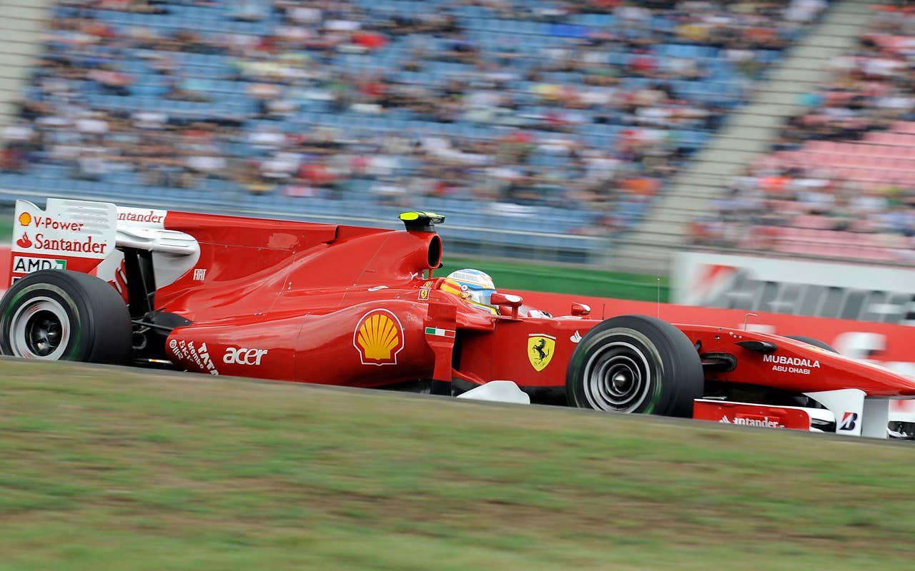 Ferrari driver Fernando Alonso of Spain  drives on the second place during the Qualifying at the race track in Hockenheim, Germany, Saturday, July 24, 2010. Sebastian Vettel of Germany has edged Fernando Alonso  to take pole position for the Formula One German Grand Prix. Vettel's  Red Bull was .002 seconds faster than Alonso's Ferrari on Saturday to give the German his sixth pole of the season. Felipe Massa of Brazil in the second Ferrari, who was third, and Mark Webber in the second Red Bull complete the two front rows for Sunday's race.    (AP Photo/Martin Meissner)